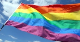 What is behind the rainbow flag